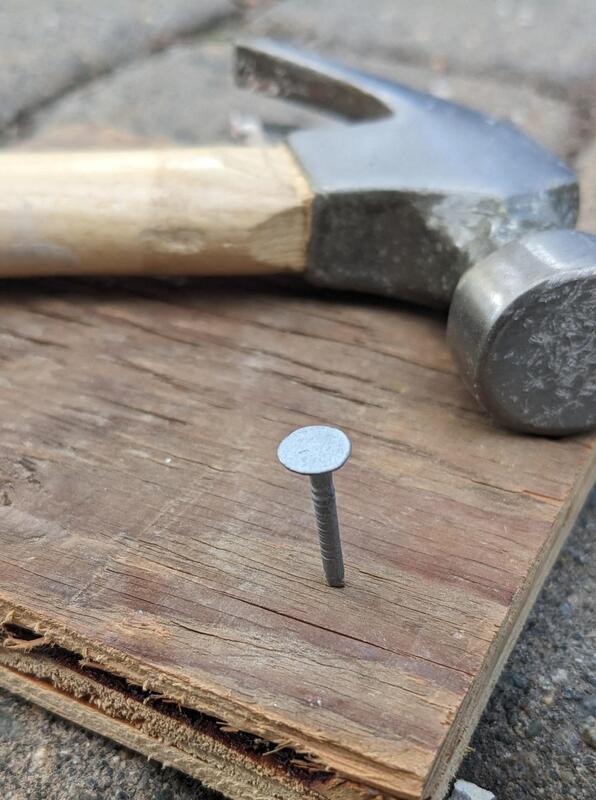 Nail in wood with hammer